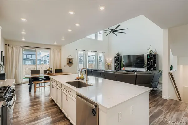 a large kitchen with stainless steel appliances a lot of counter space and a wooden floor