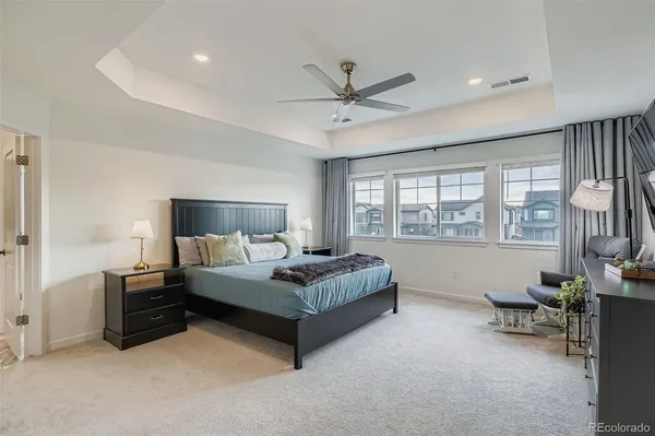 a spacious bedroom with a bed and a window