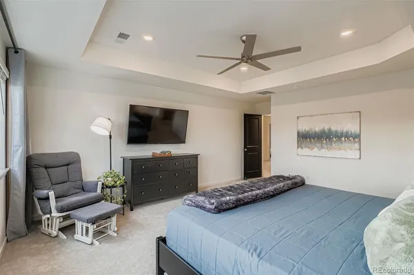 a bedroom with furniture and a flat screen tv