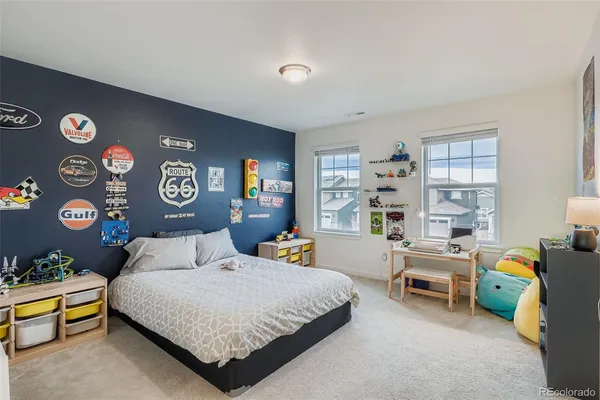 a bedroom with a bed and a desk in it