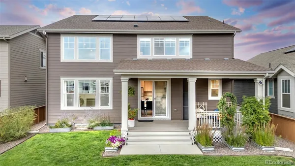 a front view of a house with a yard and plants