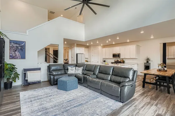 a living room with furniture a dining table and kitchen view