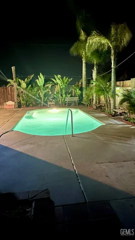 a view of a tennis ground with lawn chairs