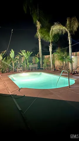 a green field with some trees in front of it