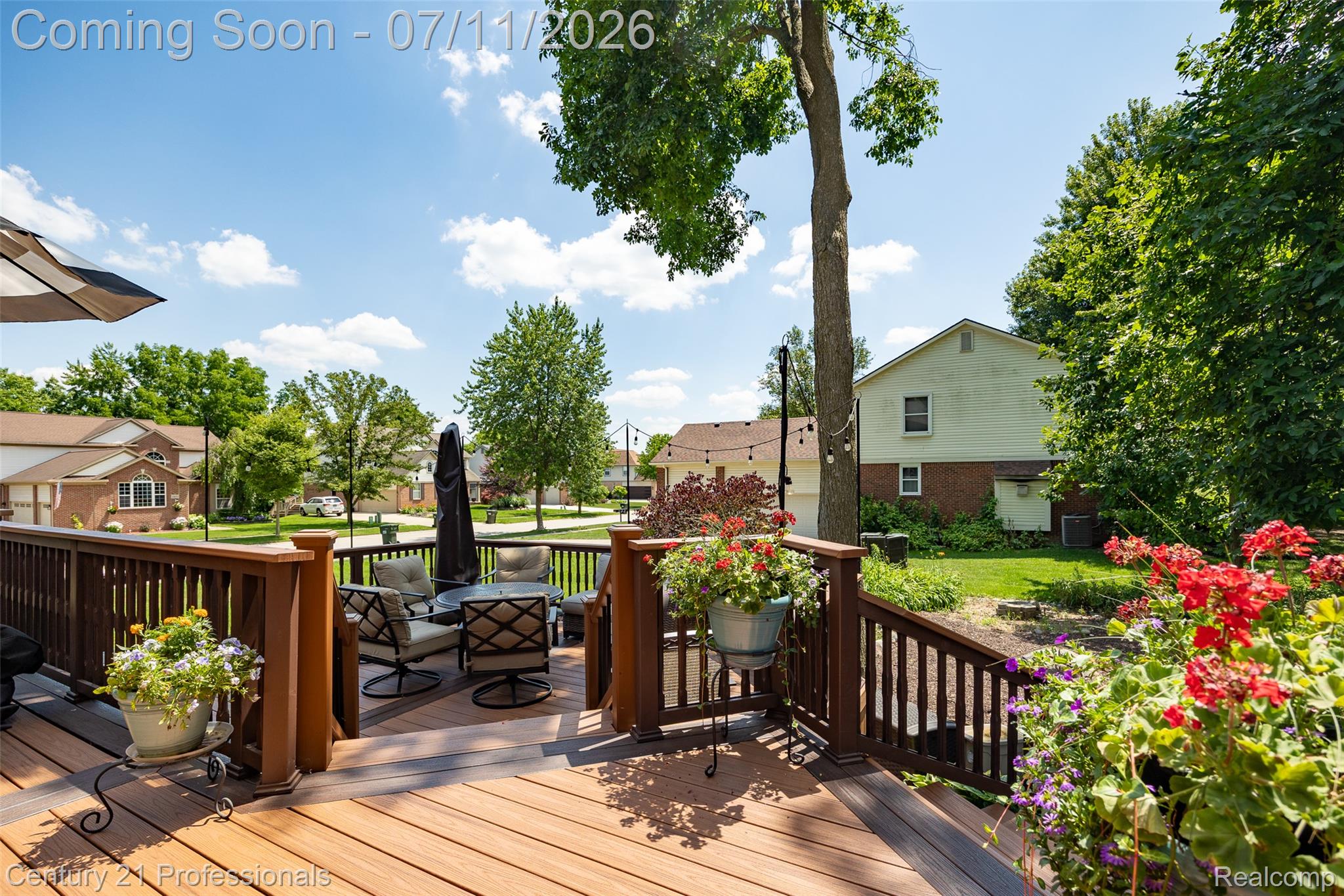 689 Woodfield Way Rochester, MI 48307 - Photo 28 of 61 Multi-level wood-finish composite deck featuring a slatted railing system and integrated steps