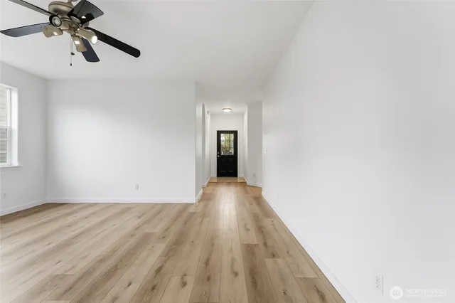 wooden floor in an empty room with a window