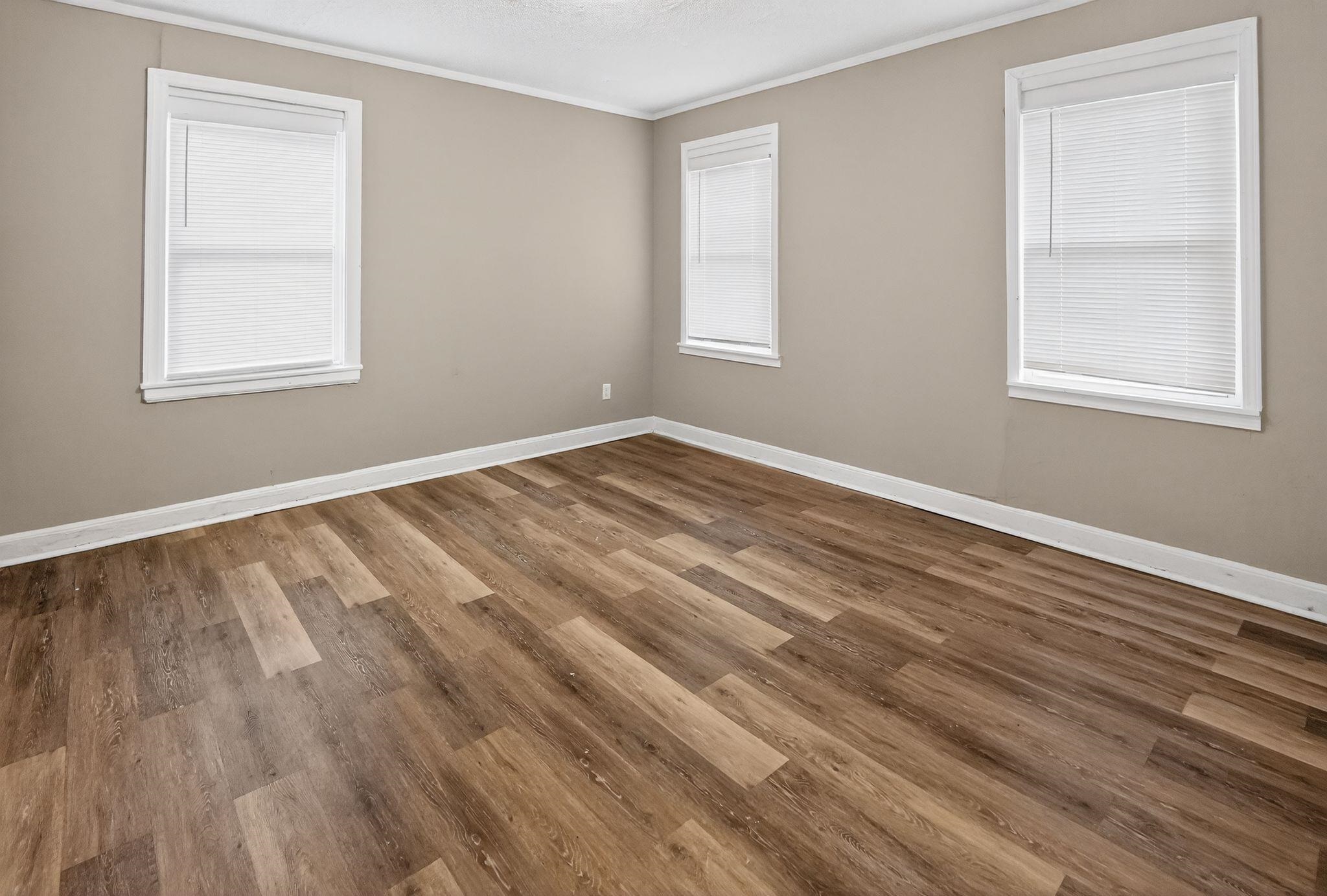 356 Hewlett Road Memphis, TN 38109 - Photo 20 of 30 a view of an empty room with wooden floor and a window