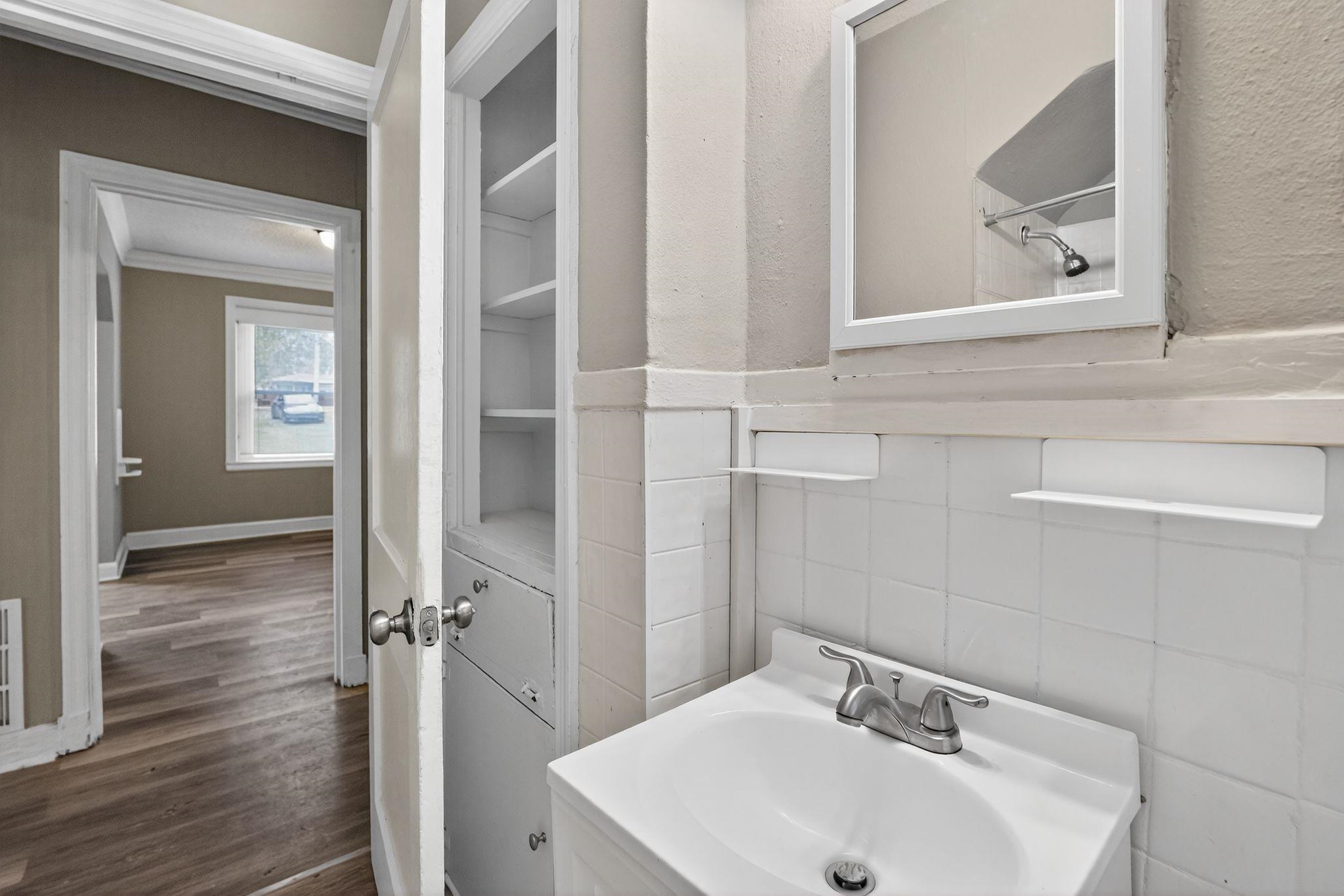 356 Hewlett Road Memphis, TN 38109 - Photo 27 of 30 a bathroom with a sink and mirror with toilet