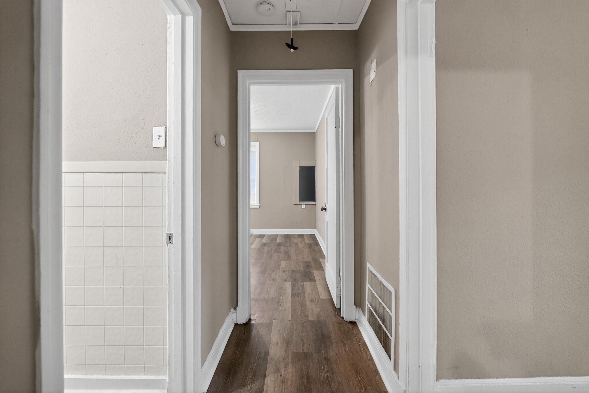 356 Hewlett Road Memphis, TN 38109 - Photo 29 of 30 a view of a hallway with wooden floor and staircase