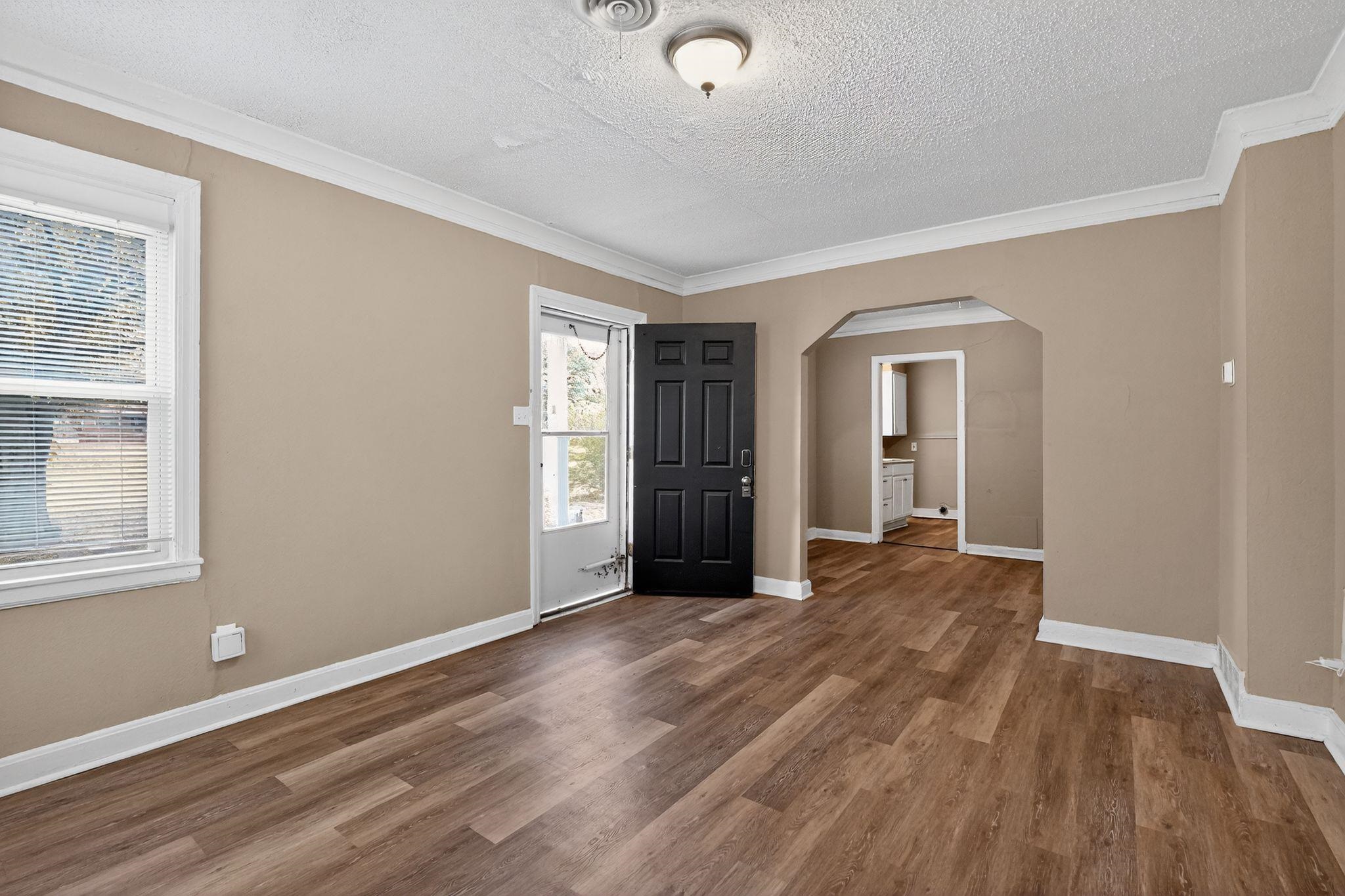 356 Hewlett Road Memphis, TN 38109 - Photo 5 of 30 a view of an empty room with wooden floor and a window