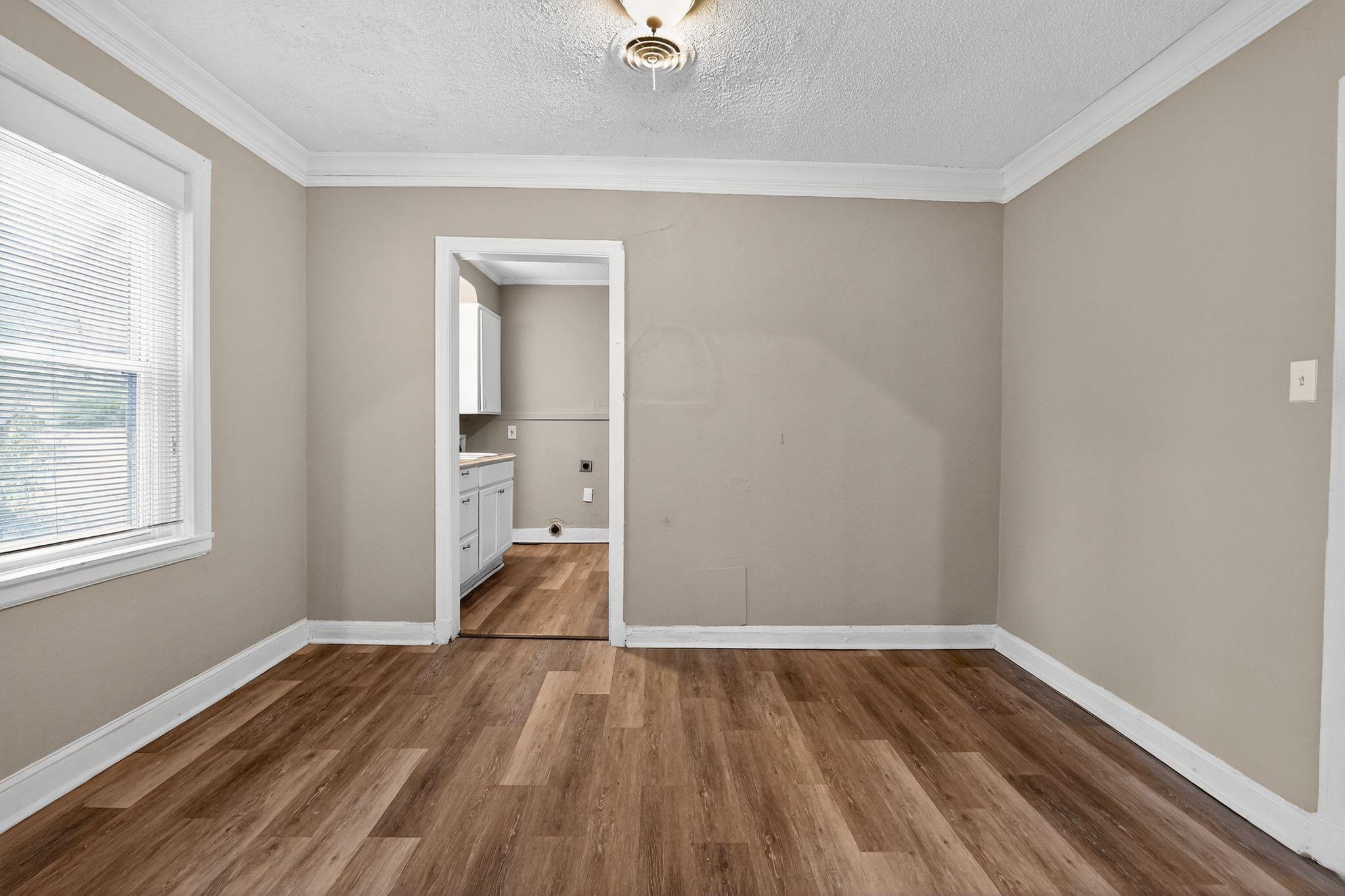 356 Hewlett Road Memphis, TN 38109 - Photo 8 of 30 wooden floor in an empty room with a window