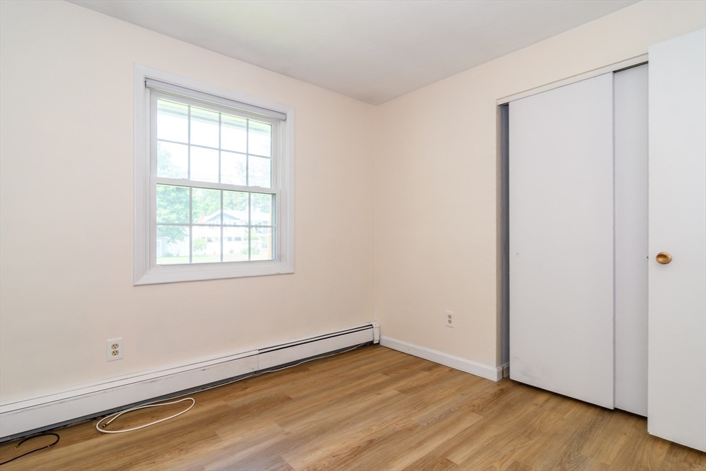 33 Eisenhower Road Framingham, MA 01701 - Photo 13 of 20 an empty room with wooden floor and windows