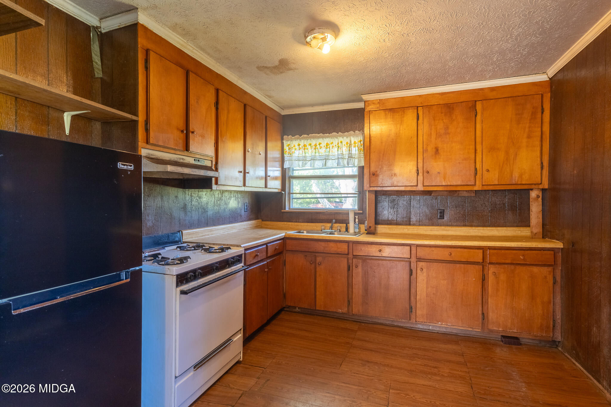347 Peavy Street Unadilla, GA 31091 - Photo 3 of 15 a kitchen with stainless steel appliances granite countertop a stove a sink and a refrigerator