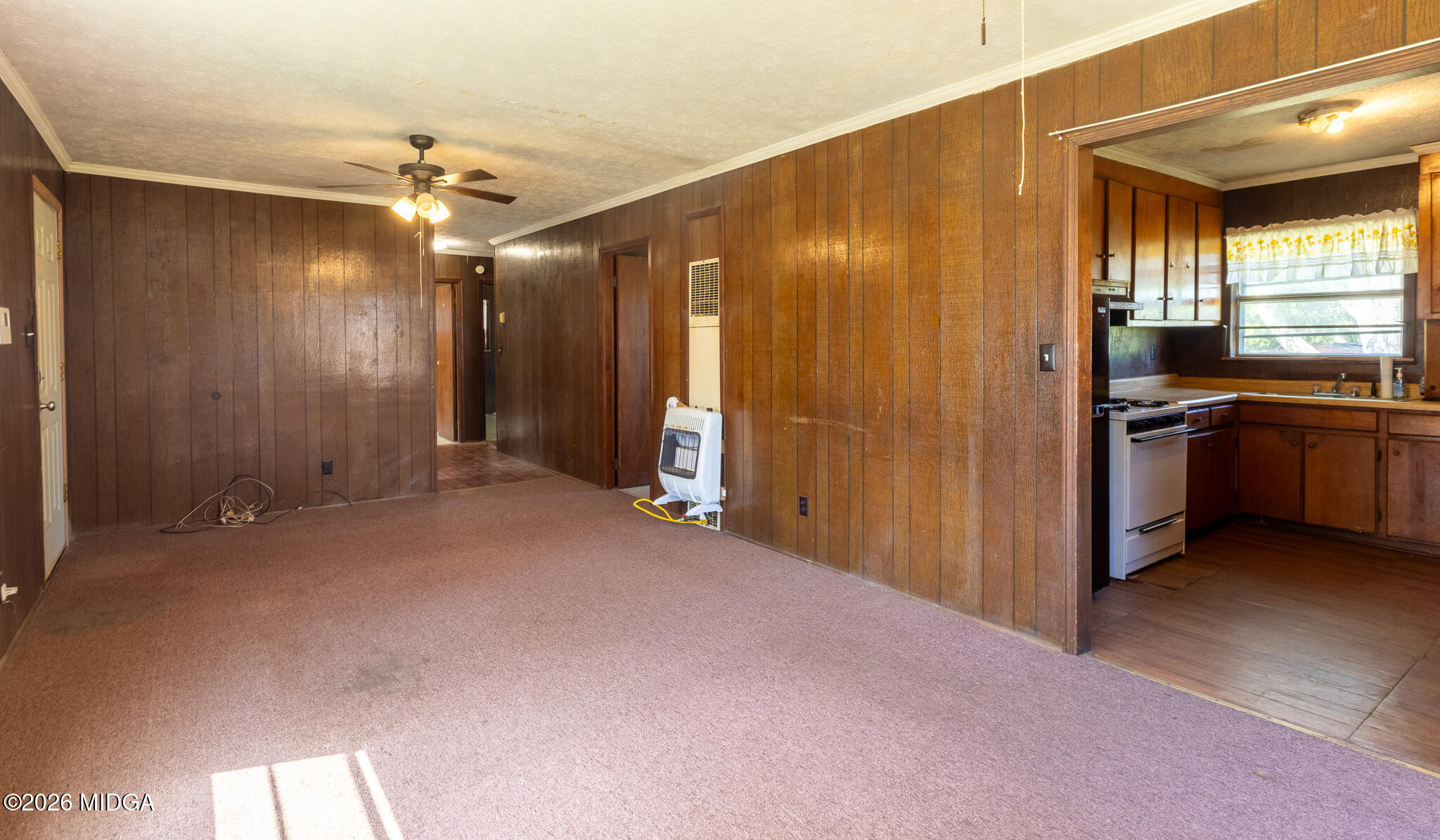 347 Peavy Street Unadilla, GA 31091 - Photo 5 of 15 a view of a livingroom with a chandelier fan and kitchen view