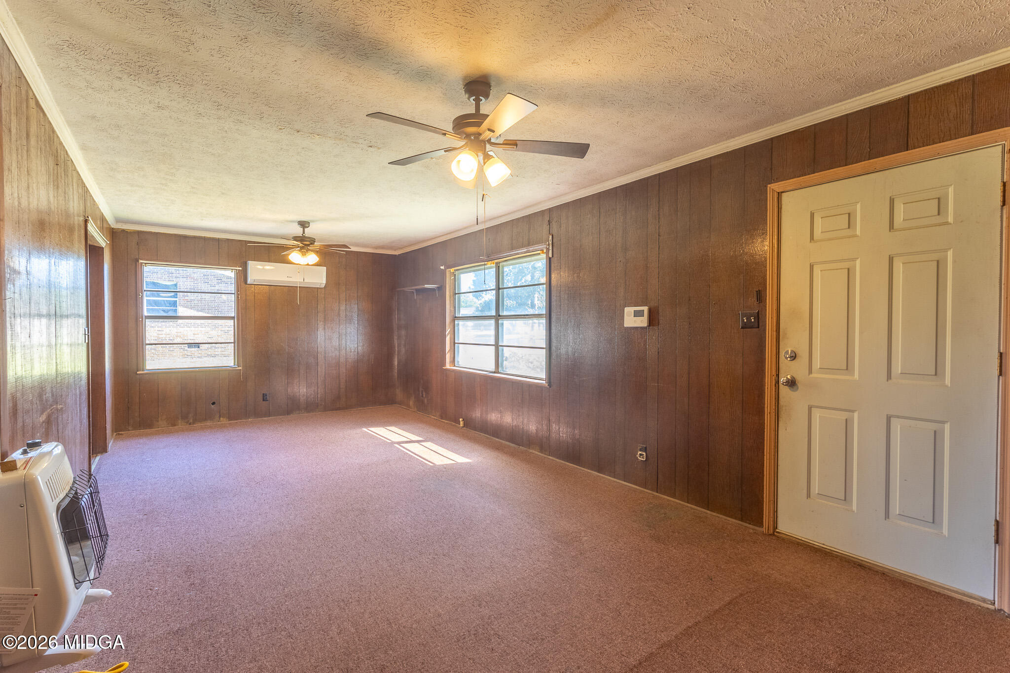 347 Peavy Street Unadilla, GA 31091 - Photo 6 of 15 an empty room with windows and fan