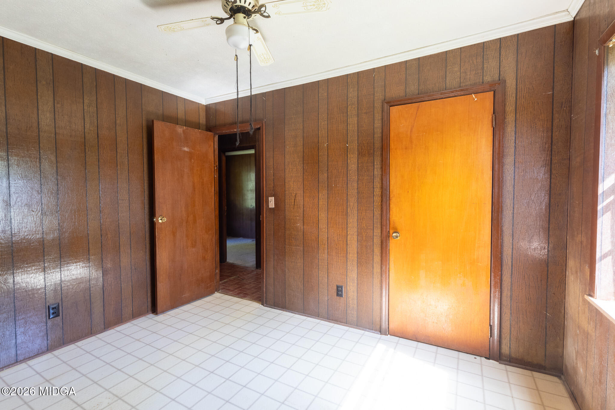 347 Peavy Street Unadilla, GA 31091 - Photo 10 of 15 a bedroom with a bed and a chandelier