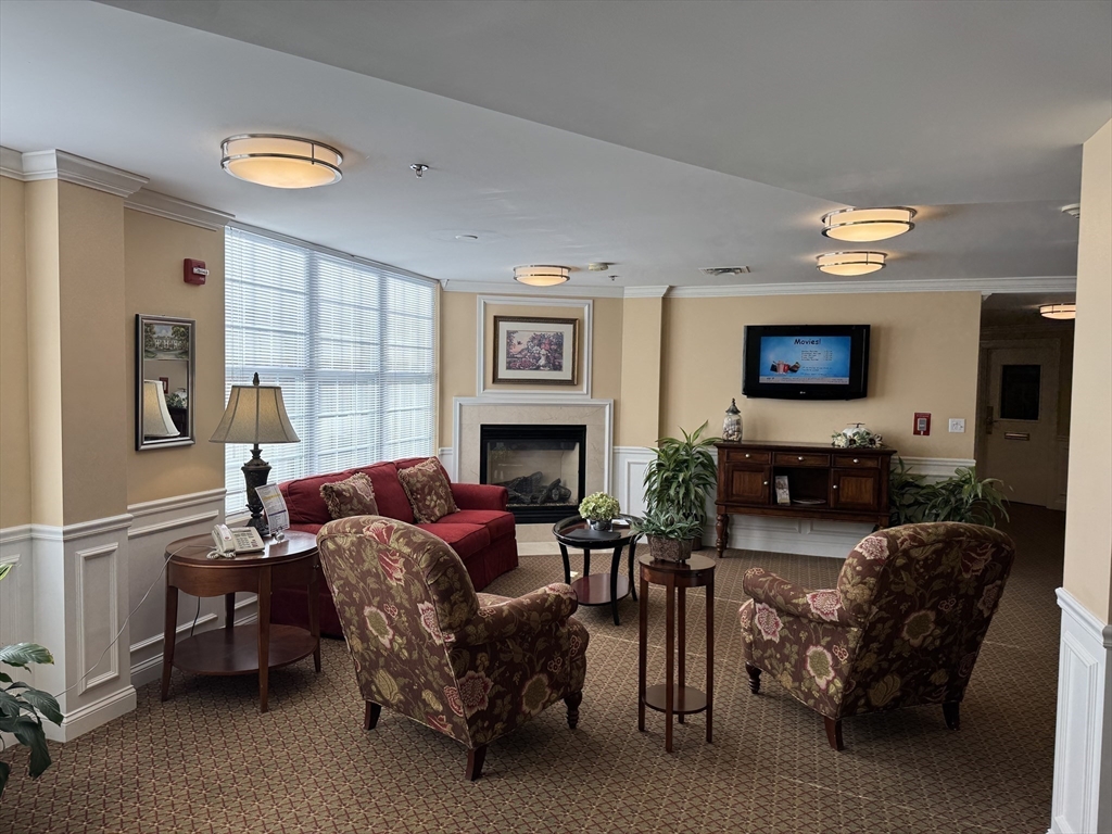 101 Barry Road, Unit 1215 Worcester, MA 01609 - Photo 1 of 14 a living room with furniture and a fireplace