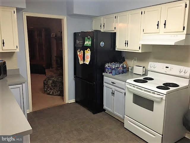 147 Morton Road Fredericksburg, VA 22405 - Photo 4 of 11 a kitchen with a refrigerator stove and cabinets