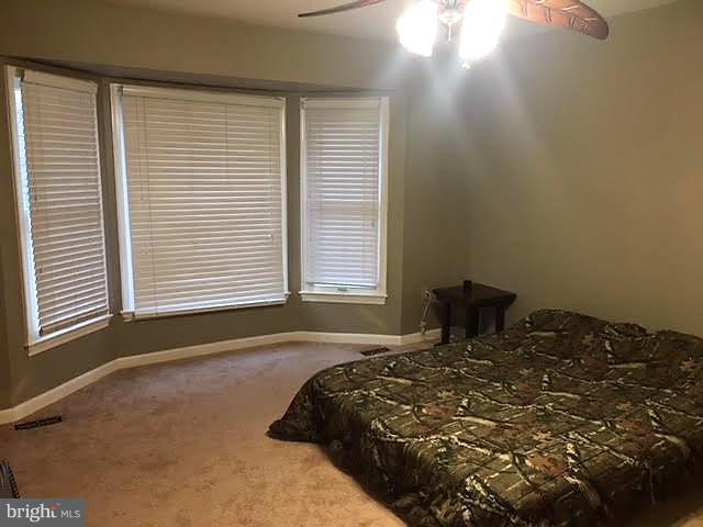 147 Morton Road Fredericksburg, VA 22405 - Photo 7 of 11 a bed sitting in a bedroom next to a window