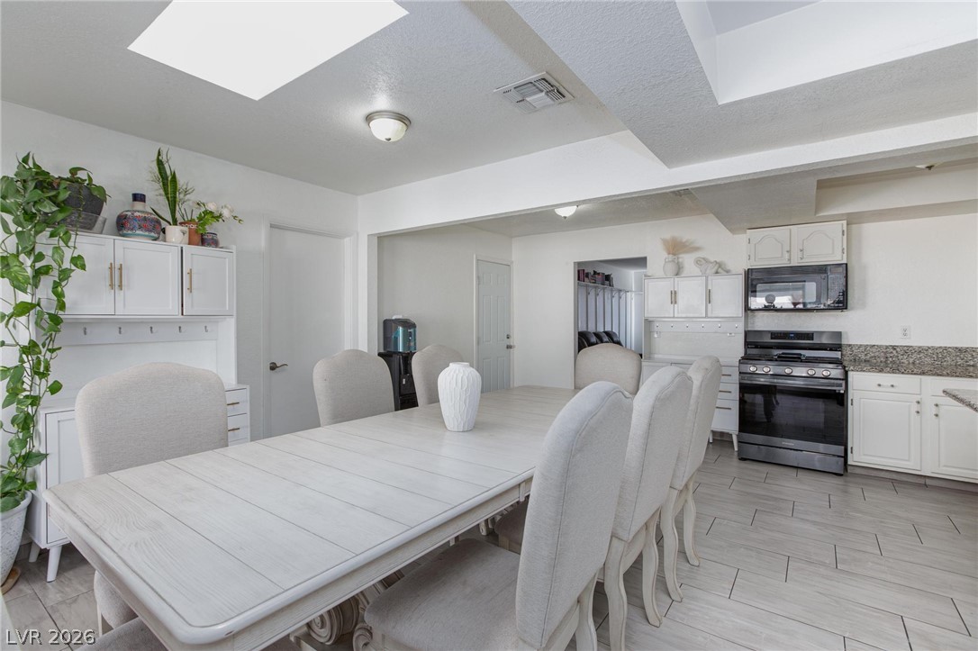 3640 North Walnut Road Las Vegas, NV 89115 - Photo 9 of 38 Bright and open dining area offers seamless flow into the kitchen.