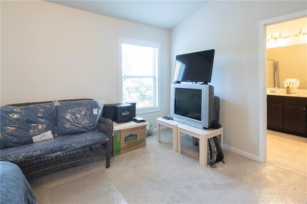 2865 Maple Park Place, Unit 44 Cumming, GA 30041 - Photo 13 of 18 a living room with furniture and a flat screen tv