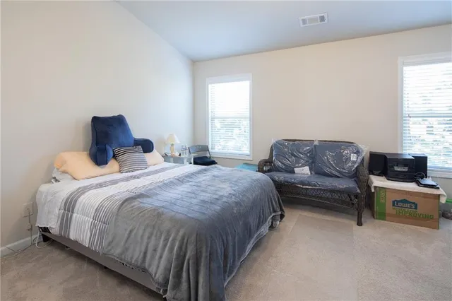 a bedroom with a bed and couch