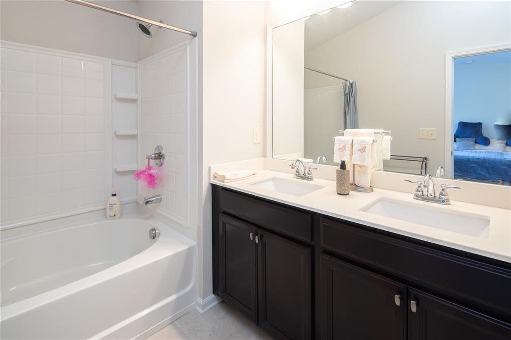 2865 Maple Park Place, Unit 44 Cumming, GA 30041 - Photo 16 of 18 a bathroom with a tub sink and a mirror