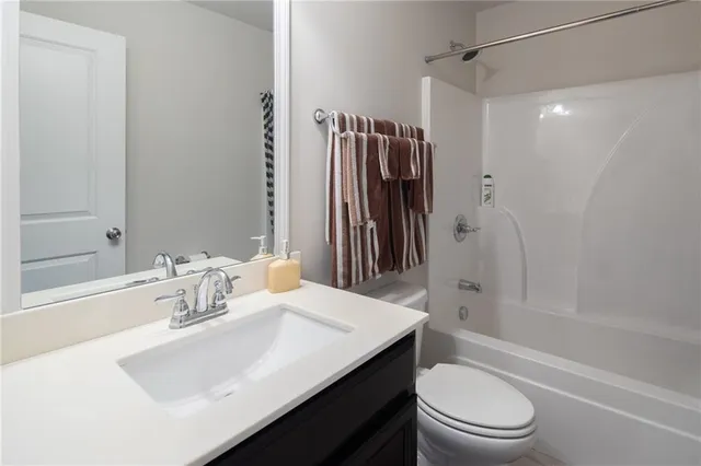 a bathroom with a sink toilet tub and shower
