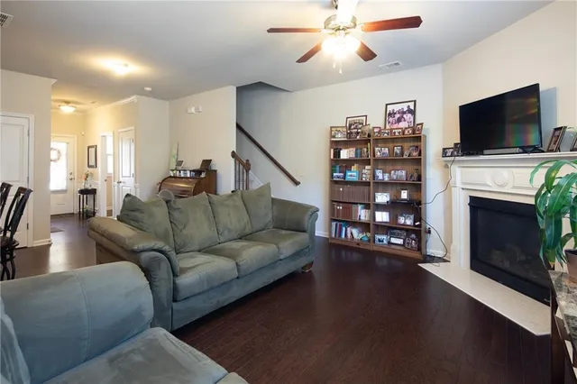 a living room with furniture a flat screen tv and a fireplace