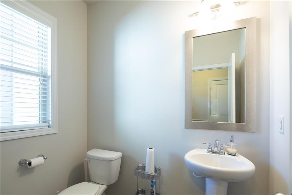 2865 Maple Park Place, Unit 44 Cumming, GA 30041 - Photo 6 of 18 a bathroom with a toilet a sink a mirror and a window