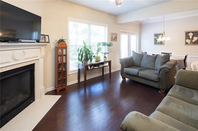 a living room with furniture fireplace and flat screen tv