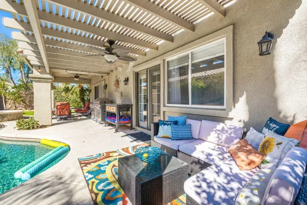 a view of a house with backyard sitting area and garden