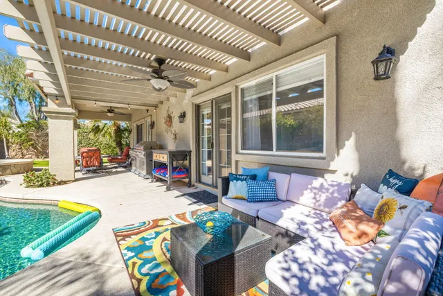 a view of a house with backyard sitting area and garden