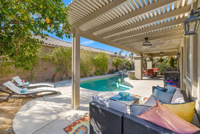a dining room with furniture a chandelier and wooden floor