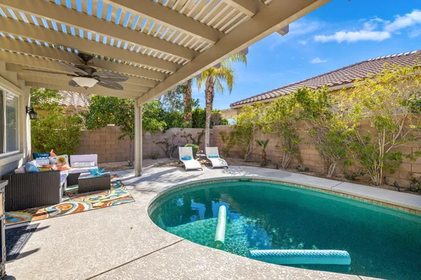a view of a dining room with furniture a chandelier and wooden floor