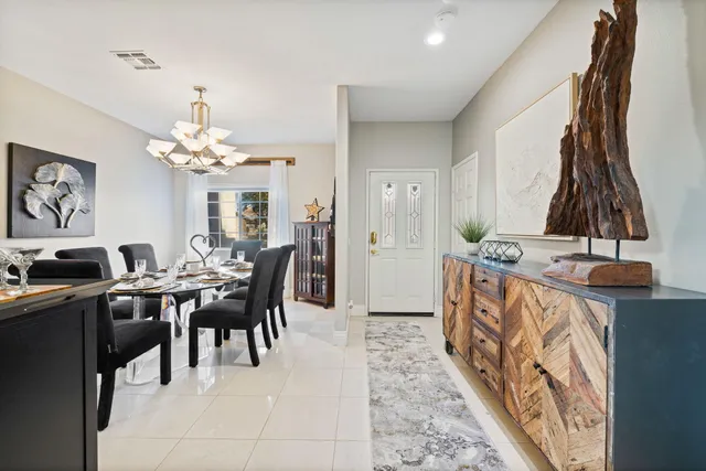a view of a dining room with furniture and chandelier