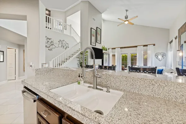 a kitchen with stainless steel appliances granite countertop a stove a sink and a refrigerator