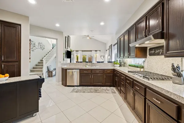 a living room with furniture and a dining table with kitchen view