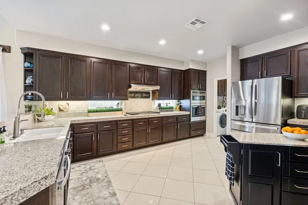 a living room with furniture and view of kitchen