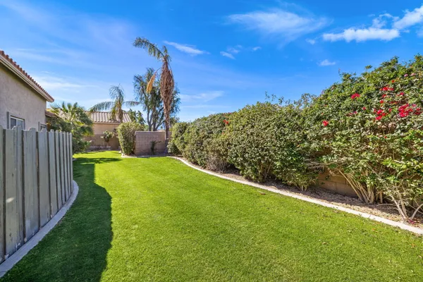 a view of a garden with a building in the background
