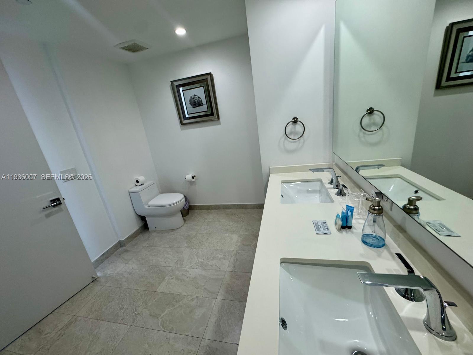 488 Northeast 18th Street, Unit 806 Miami, FL 33132 - Photo 11 of 13 a view of a bathroom with sink dryer and washer