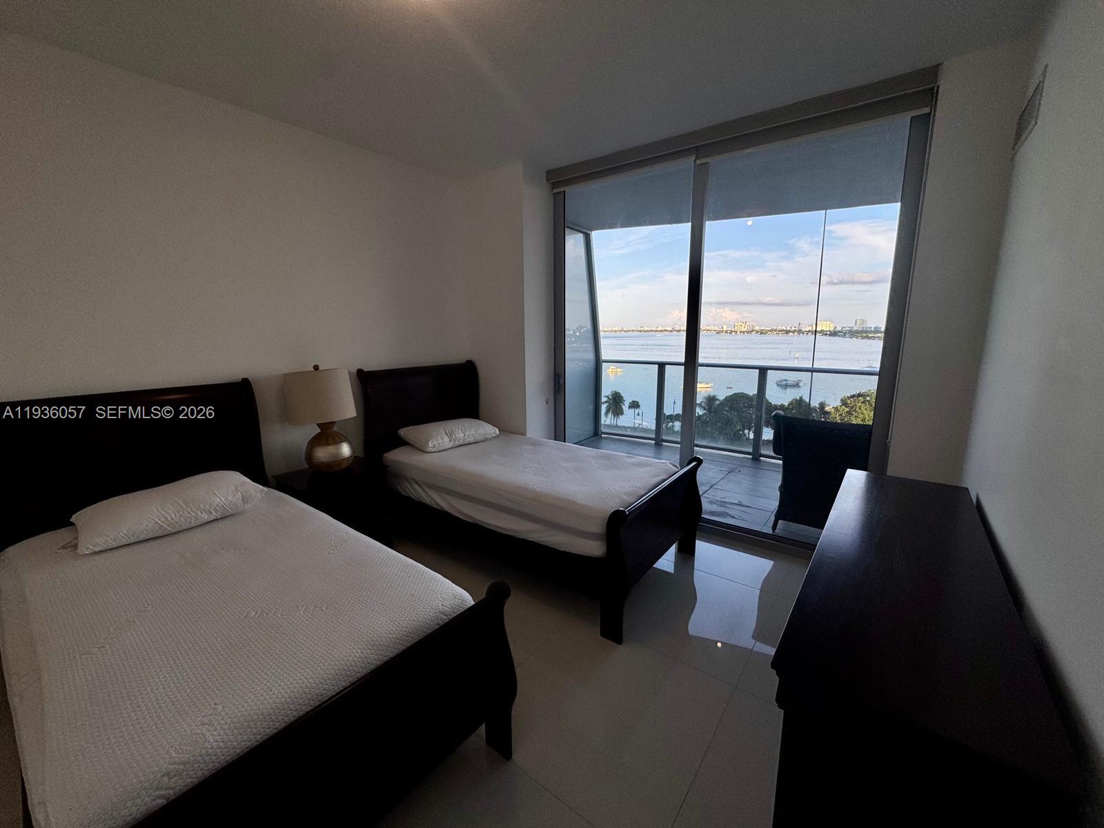 488 Northeast 18th Street, Unit 806 Miami, FL 33132 - Photo 6 of 13 a living room with two couches and a table