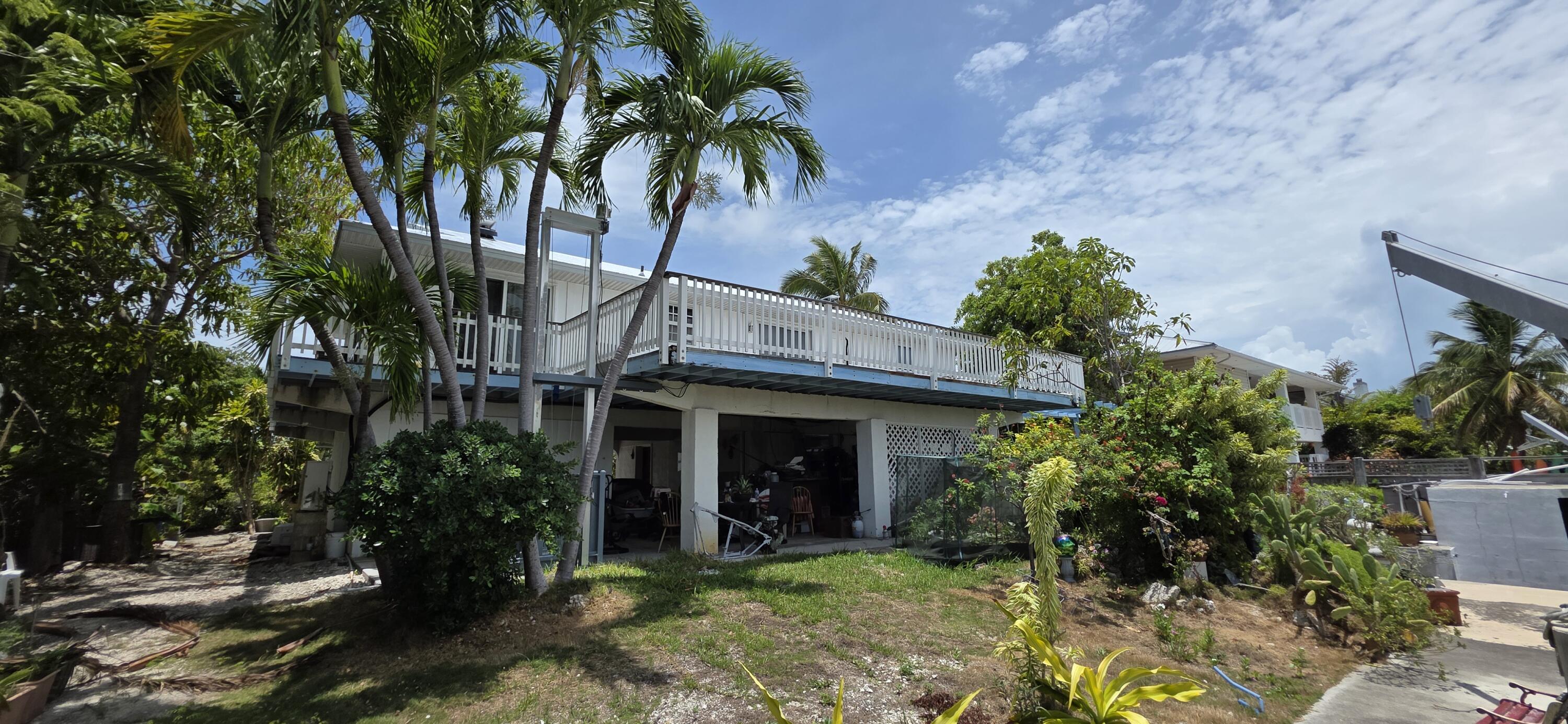 8 Emerald Drive Key West, FL 33040 - Photo 21 of 43 a view of a house with potted plants and a tree