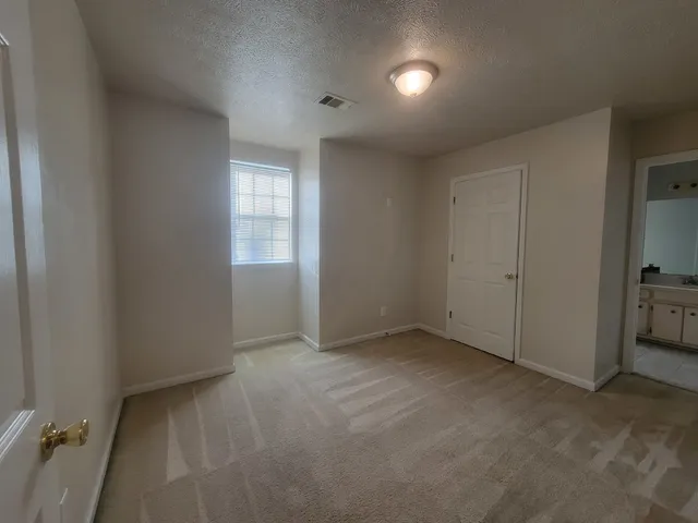 an empty room with closet area