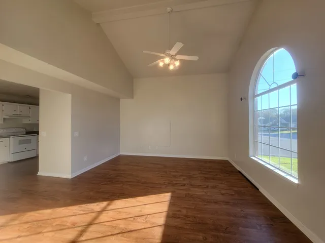wooden floor in an empty room with a window
