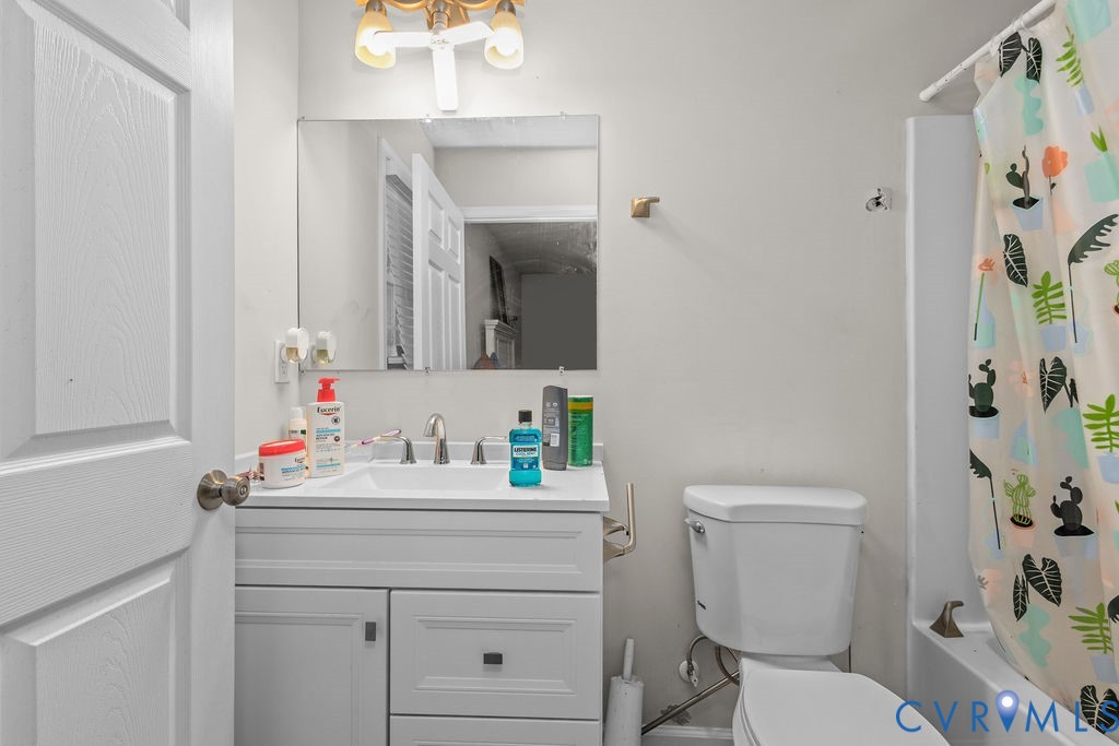 829 Rome Street Petersburg, VA 23803 - Photo 13 of 20 a bathroom with a sink vanity mirror and toilet