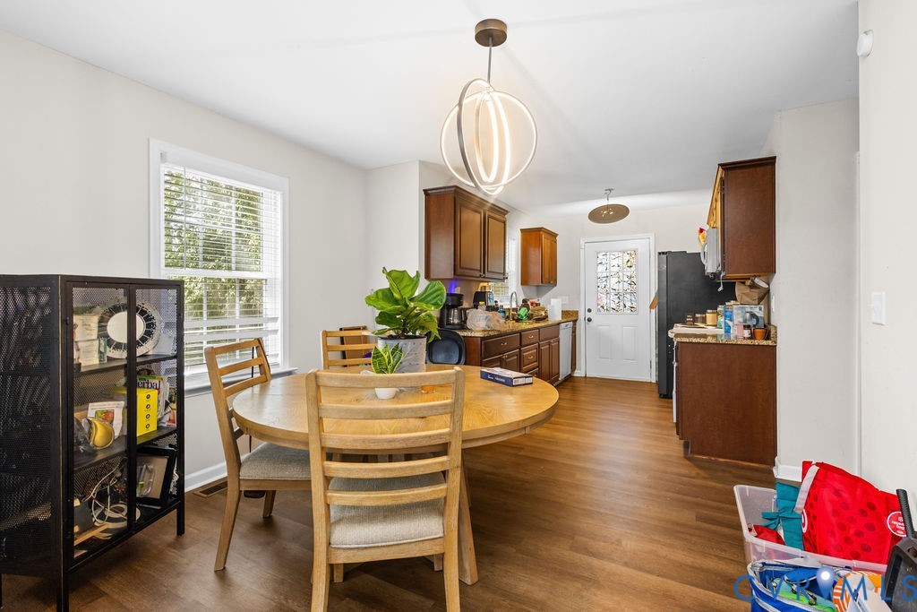 829 Rome Street Petersburg, VA 23803 - Photo 8 of 20 a view of a dining room with furniture a chandelier and wooden floor