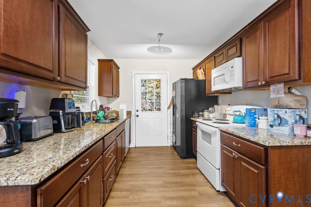 829 Rome Street Petersburg, VA 23803 - Photo 9 of 20 a kitchen with granite countertop a sink stove refrigerator and cabinets