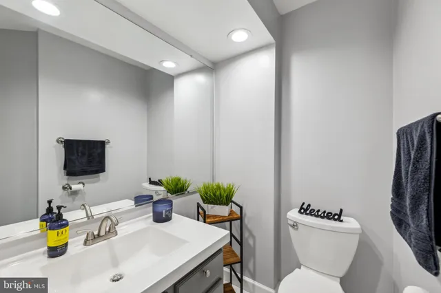 a bathroom with a sink a toilet and a mirror