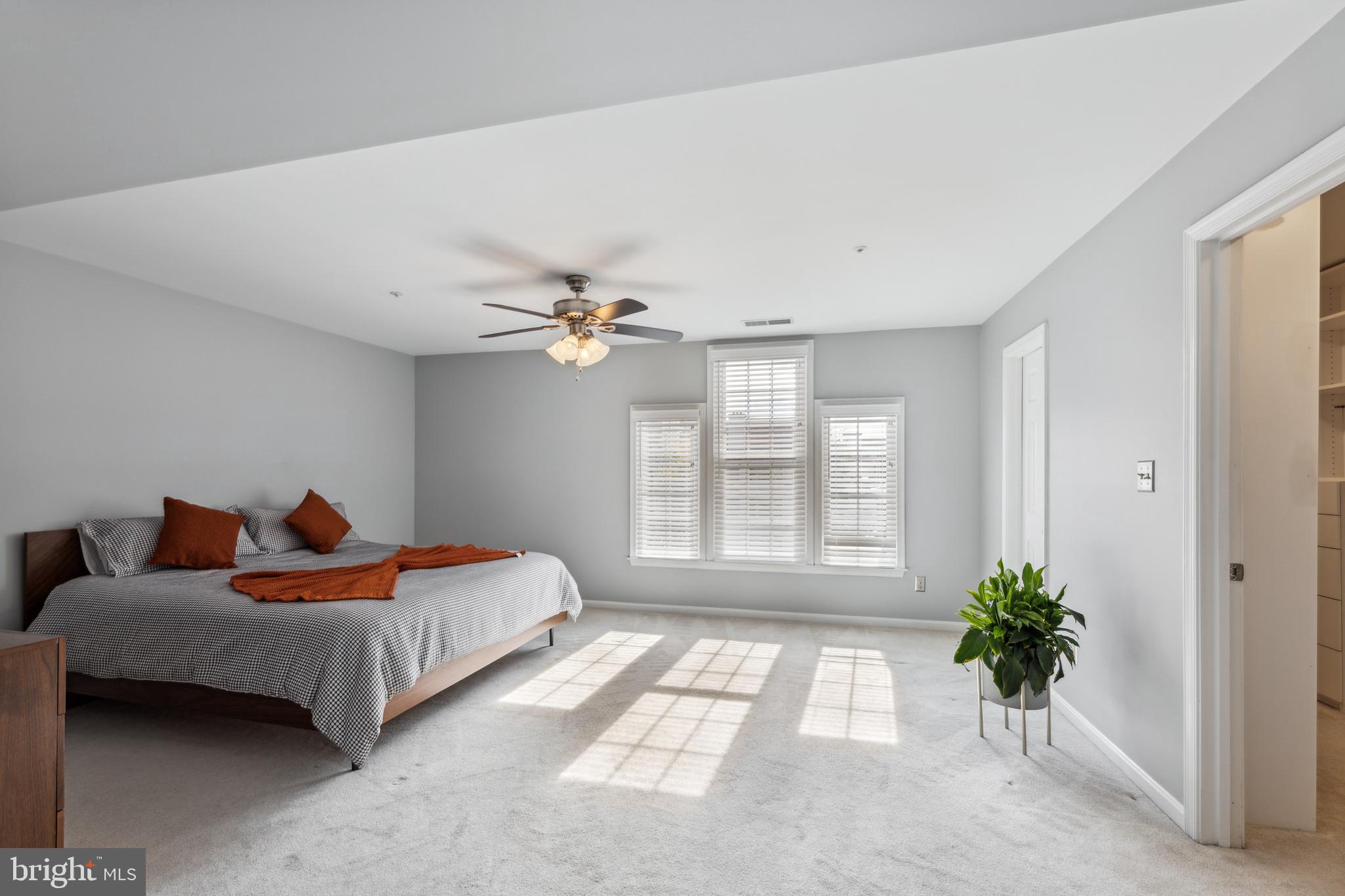 6934F Ellingham Circle Alexandria, VA 22315 - Photo 14 of 34 a bedroom with a bed and a chandelier